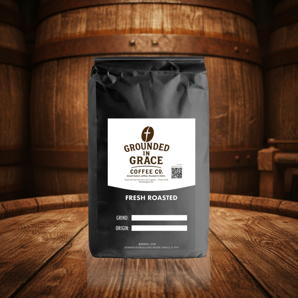 Grounded in Grace Coffee Co. coffee bag on a wooden surface with barrels in the background