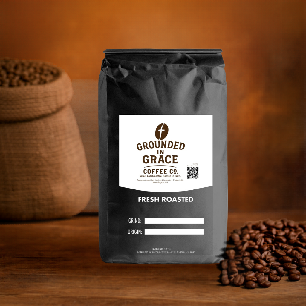 Grounded in Grace Coffee Co. bag with coffee beans on a wooden surface