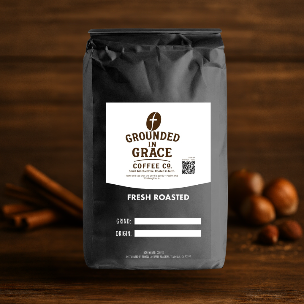 Black coffee bag with 'Grounded in Grace Coffee Co.' label on a wooden background
