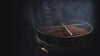 Coffee beans being roasted in a coffee roaster with smoke